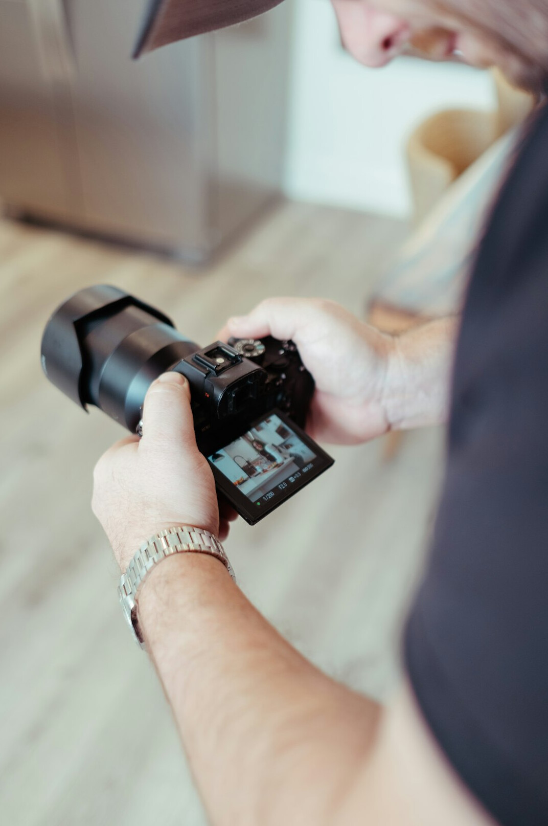 Broadcast camera operator holding a professional video camera in a studio