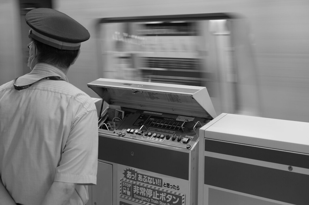 Broadcast engineer adjusting signal equipment in an equipment rack